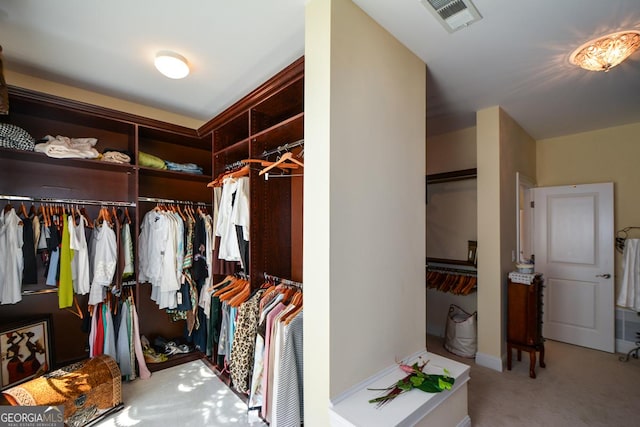 spacious closet with visible vents and carpet flooring