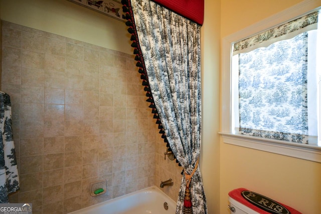 bathroom featuring shower / bath combo and toilet