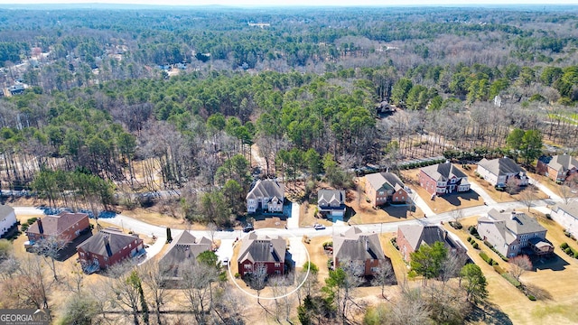 aerial view featuring a wooded view and a residential view