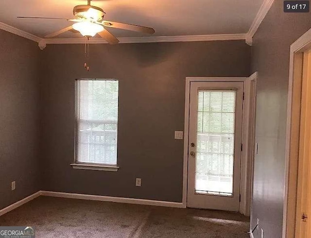 doorway to outside featuring ornamental molding, carpet flooring, a ceiling fan, and baseboards