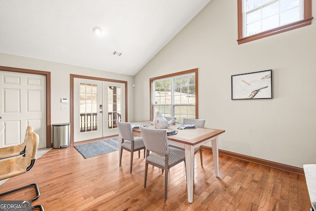 office area featuring french doors, visible vents, high vaulted ceiling, light wood-type flooring, and baseboards