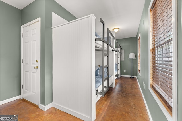 interior space with concrete floors and baseboards