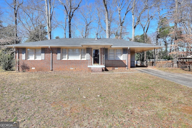 view of front of house featuring aphalt driveway, brick siding, crawl space, a carport, and a front yard