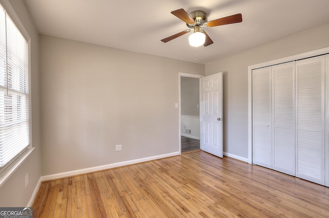 unfurnished bedroom featuring visible vents, a ceiling fan, baseboards, a closet, and light wood-type flooring