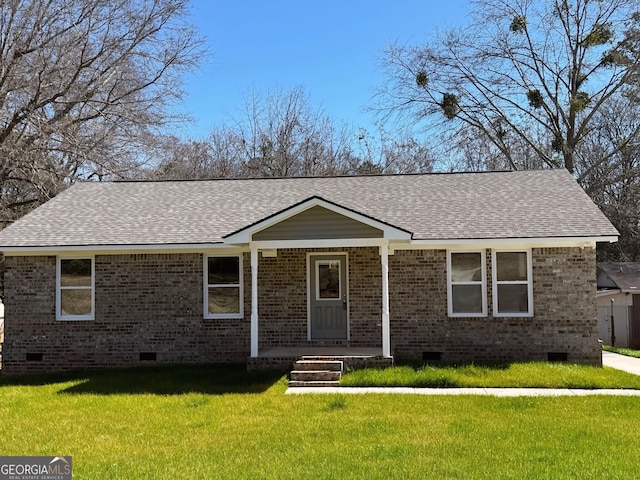 view of front of house featuring roof with shingles, brick siding, crawl space, and a front yard