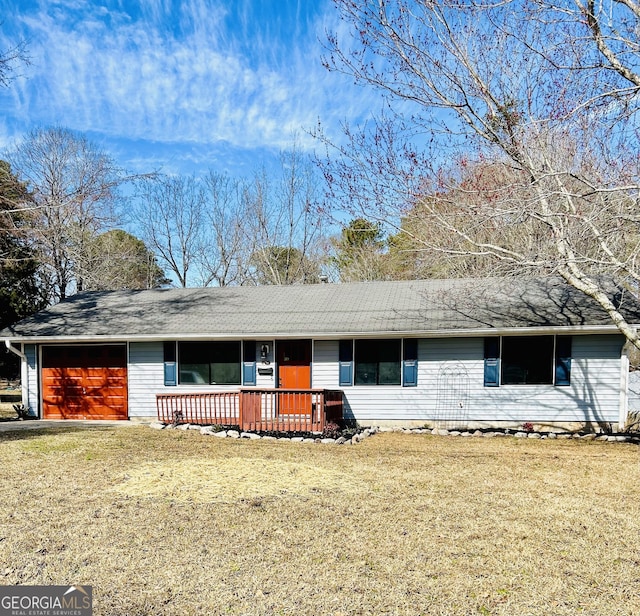 ranch-style home with a garage and a front yard