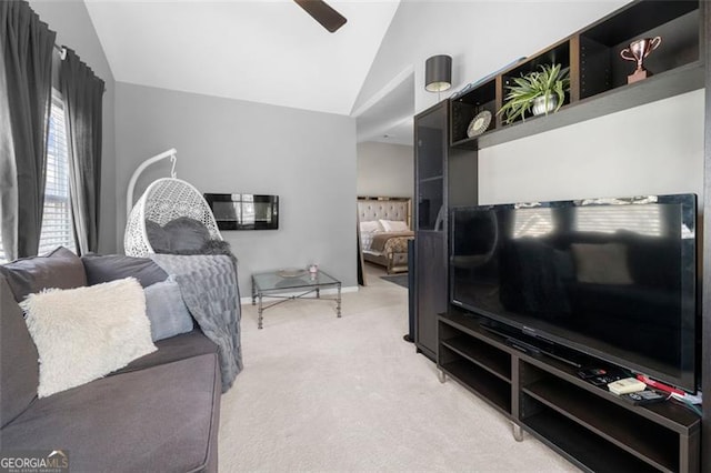 living area featuring lofted ceiling, ceiling fan, and light carpet