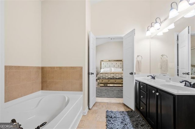 ensuite bathroom featuring a sink, double vanity, ensuite bath, and a garden tub