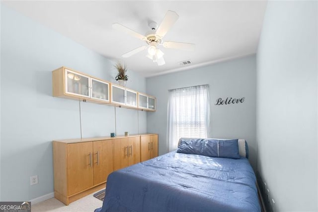 bedroom featuring visible vents, ceiling fan, light carpet, and baseboards