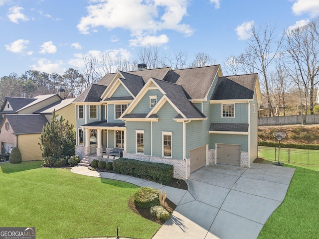 view of front facade featuring driveway, an attached garage, covered porch, fence, and a front lawn