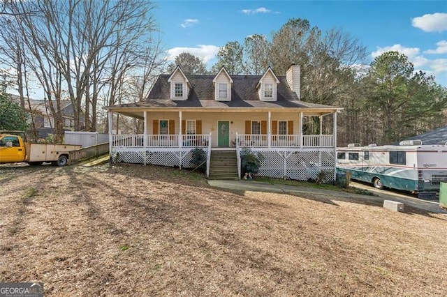 country-style home with a front lawn and a porch