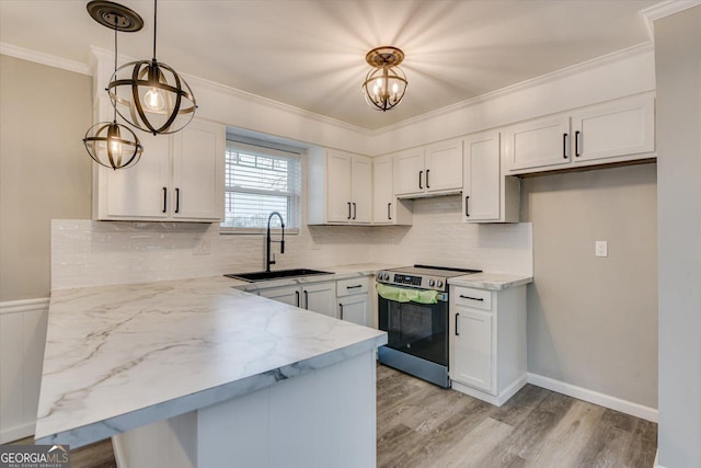 kitchen with crown molding, hanging light fixtures, stainless steel range with electric cooktop, a sink, and white cabinetry