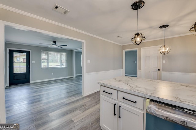 kitchen with visible vents, white cabinets, dishwasher, light stone counters, and crown molding