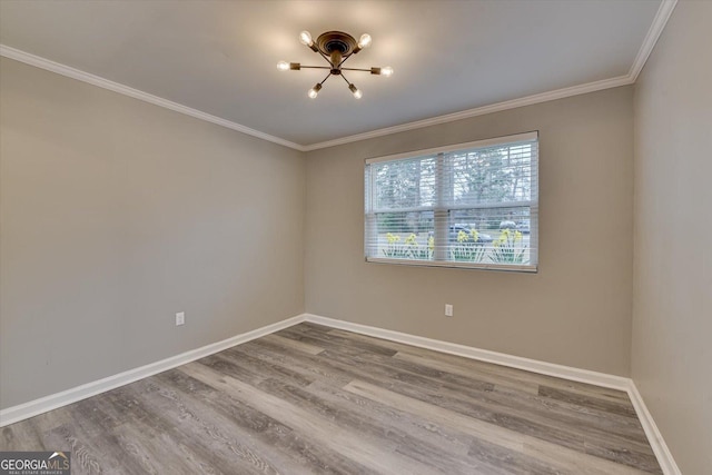 unfurnished room featuring baseboards, wood finished floors, and ornamental molding