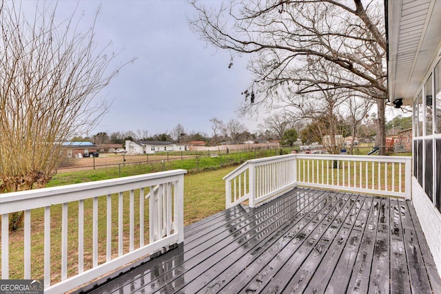 wooden terrace featuring a yard and a fenced backyard