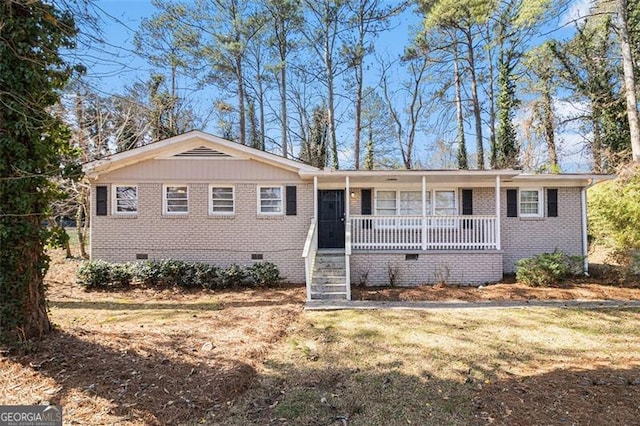 ranch-style house with crawl space, covered porch, a front lawn, and brick siding