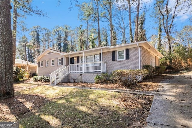 ranch-style house with a porch and brick siding