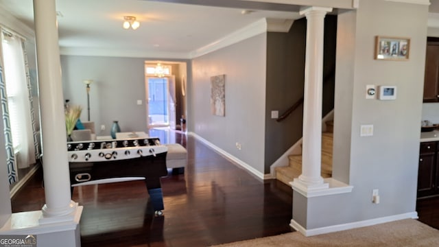 game room featuring ornamental molding, baseboards, and ornate columns