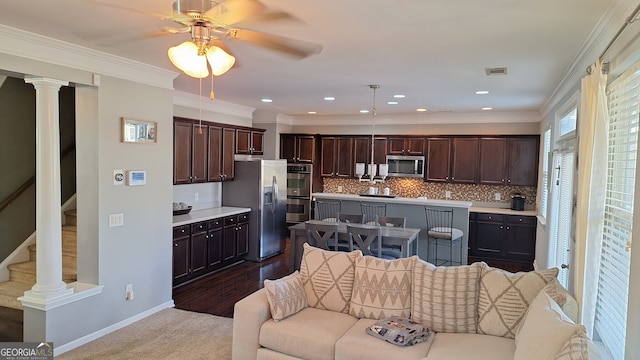 kitchen featuring visible vents, an island with sink, open floor plan, stainless steel appliances, and light countertops