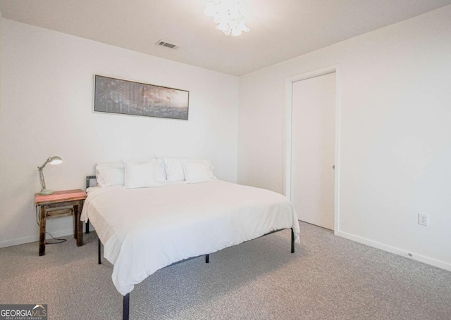 bedroom with baseboards, visible vents, and carpet flooring