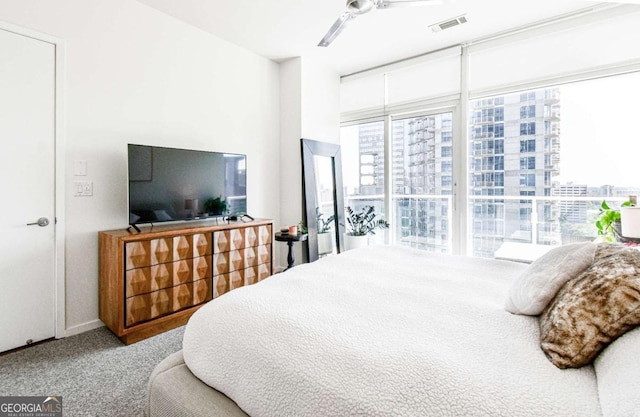 bedroom featuring carpet floors, visible vents, and ceiling fan