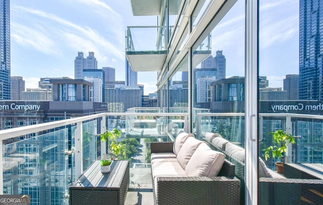 balcony with a view of city and an outdoor hangout area