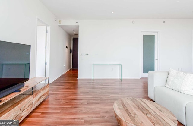 living area with baseboards and light wood-style floors