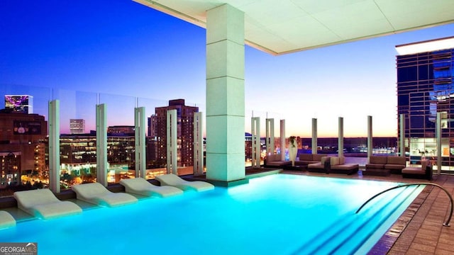 pool at dusk with a city view