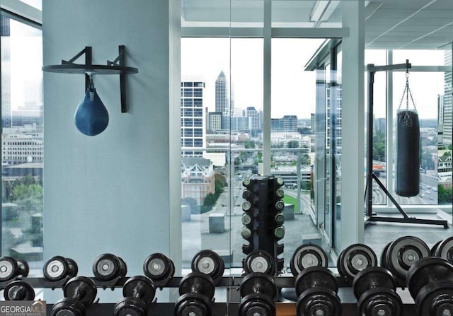 interior space with a wall of windows and a city view