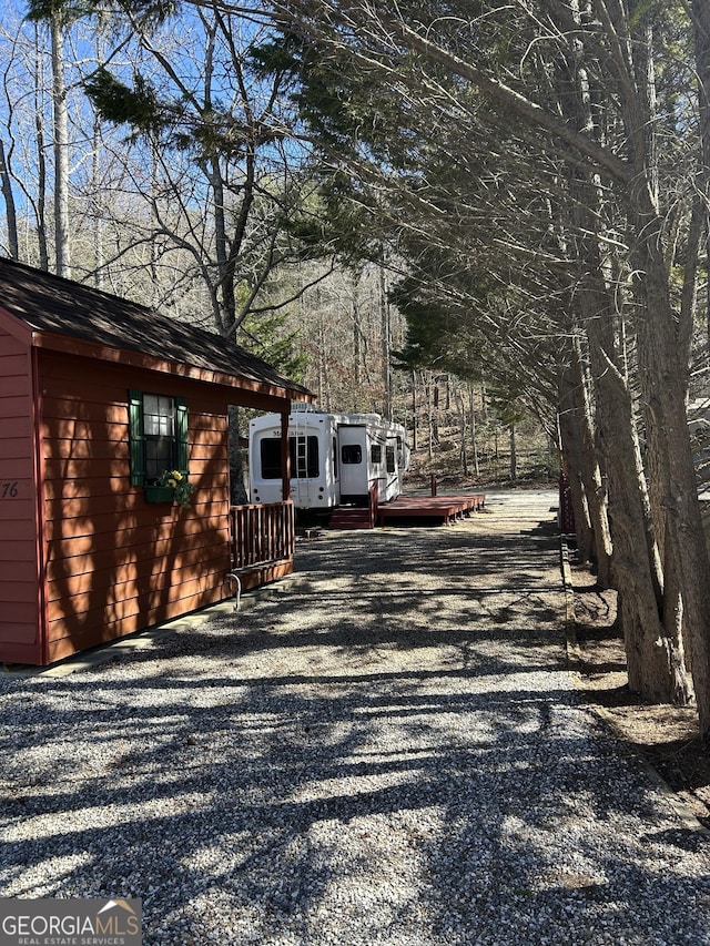 view of road with gravel driveway