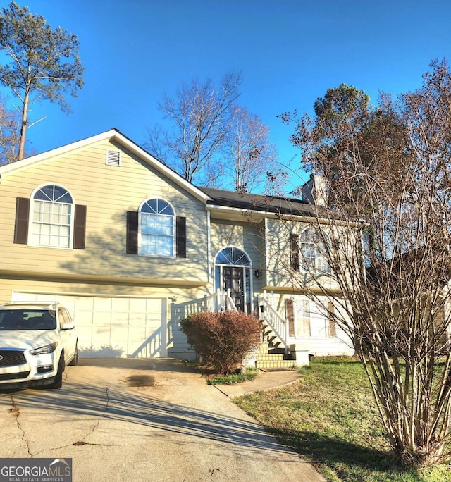 split foyer home with driveway and an attached garage