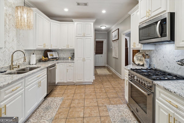 kitchen featuring visible vents, appliances with stainless steel finishes, white cabinets, and a sink