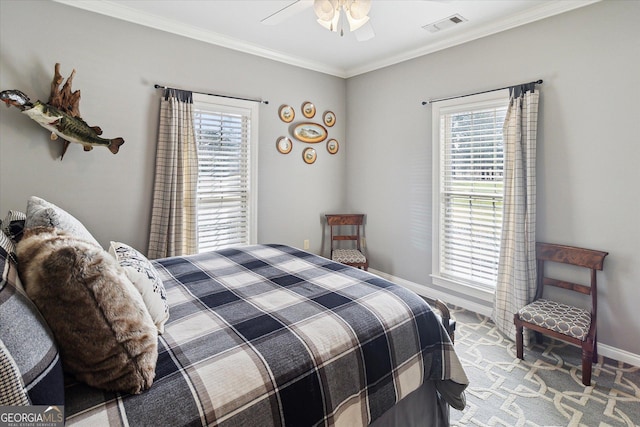 bedroom with visible vents, crown molding, baseboards, and multiple windows