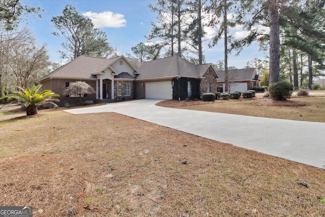 view of front of house with a garage, concrete driveway, and a front lawn