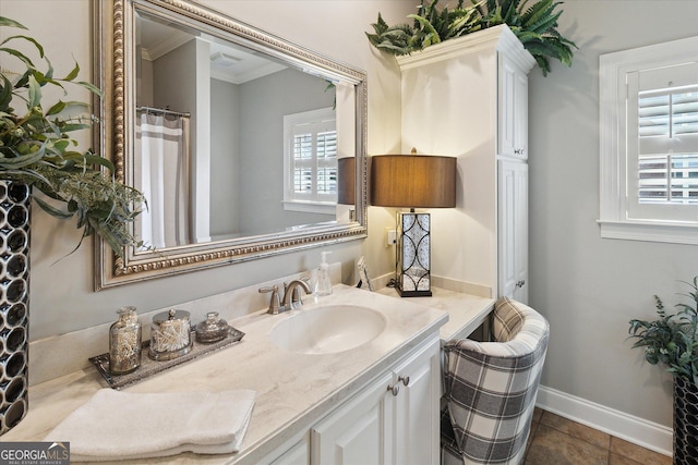 full bathroom featuring tile patterned floors, baseboards, ornamental molding, and vanity