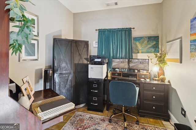 home office featuring light tile patterned floors, visible vents, and baseboards