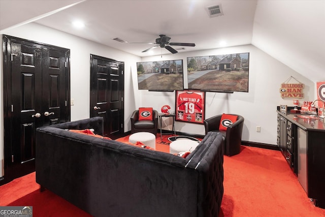 cinema room with light carpet, a sink, visible vents, a ceiling fan, and vaulted ceiling