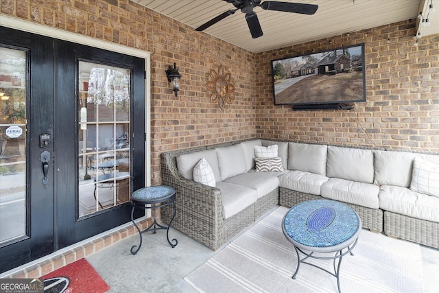 interior space with a ceiling fan, wood ceiling, and brick wall