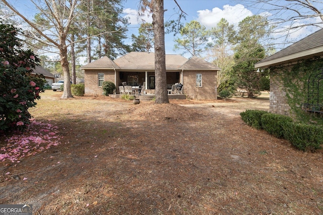 rear view of house with brick siding