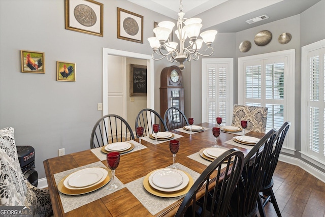 dining area featuring a chandelier, dark wood-style flooring, and visible vents