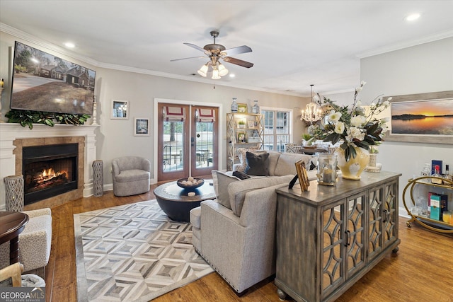 living area with a fireplace, crown molding, and light wood-style flooring