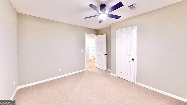 unfurnished bedroom with carpet flooring, visible vents, and baseboards