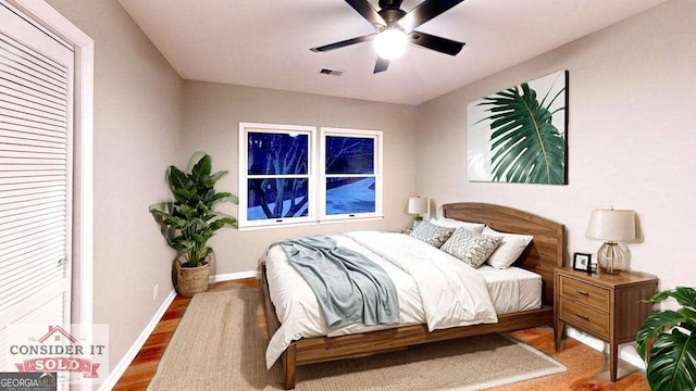 bedroom featuring a ceiling fan, baseboards, and wood finished floors