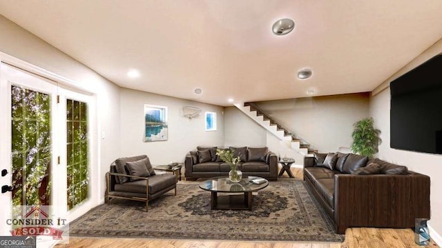 living room with light wood-style floors and stairway