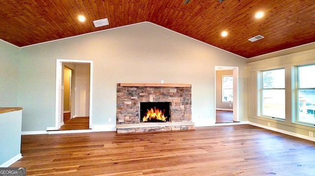 unfurnished living room with lofted ceiling, a fireplace, wood finished floors, wood ceiling, and visible vents