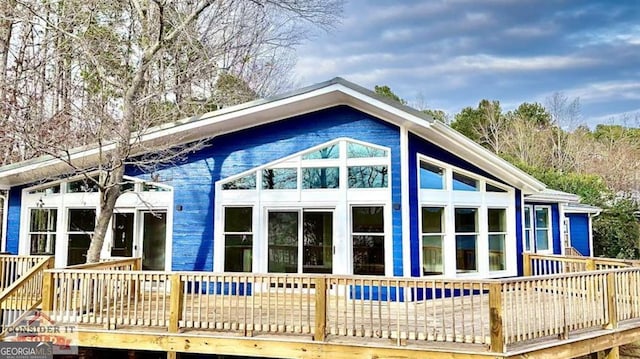 view of side of home with a wooden deck