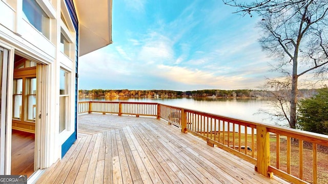 wooden terrace featuring a water view