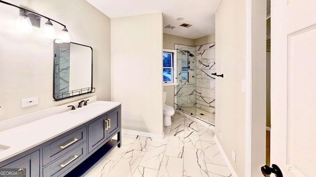 full bathroom with marble finish floor, a sink, a marble finish shower, and baseboards