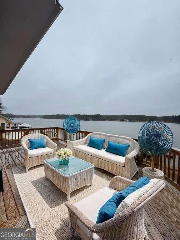 deck with a water view and an outdoor hangout area