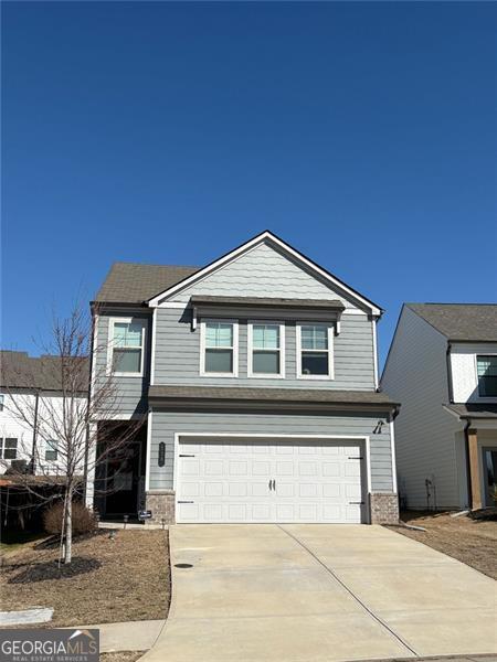 view of front of home with a garage and concrete driveway